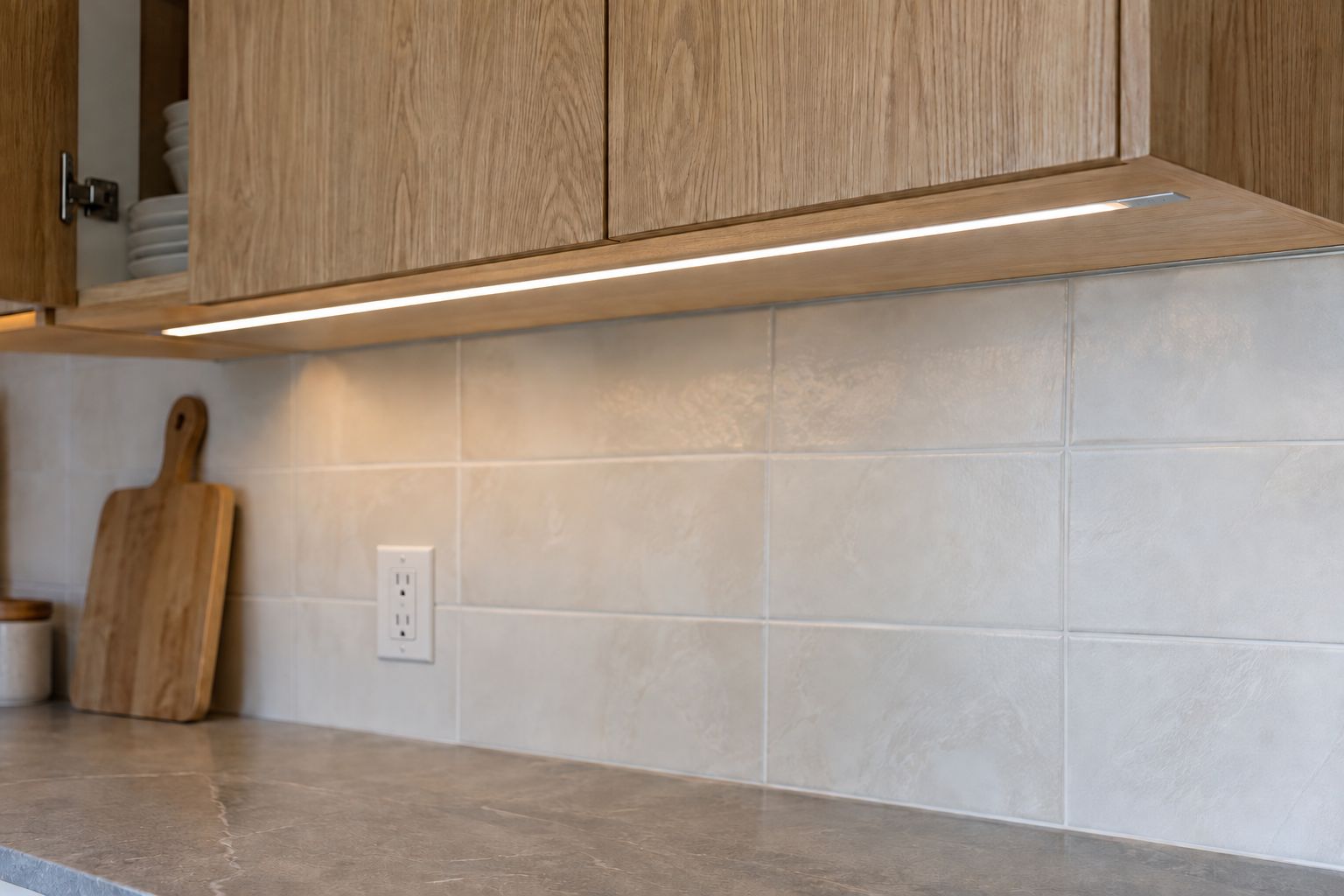 Design visualization: Recessed task light under an oak wall cabinet above a ceramic tile backsplash