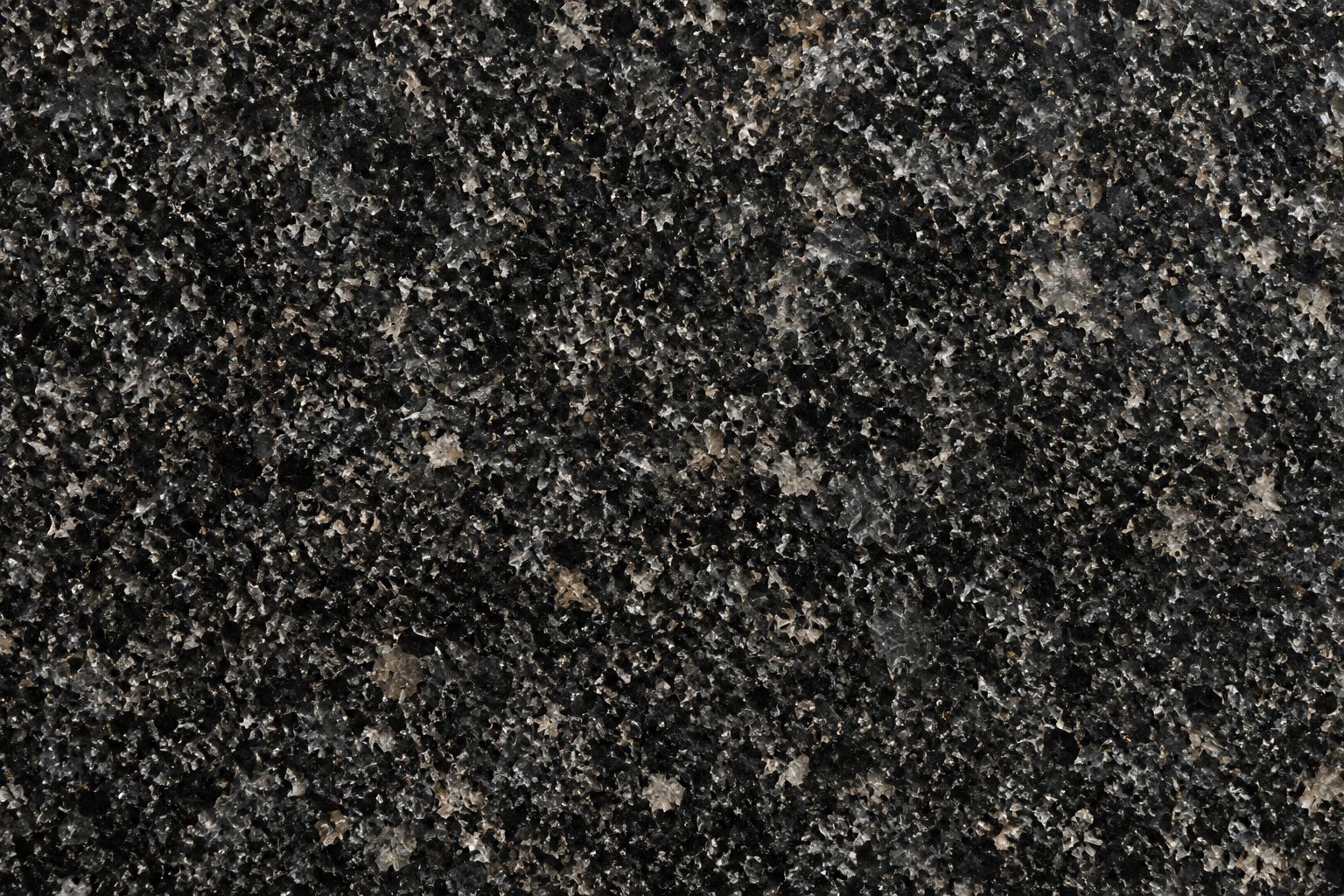 Charcoal granite with irregular silver-gray and beige mineral crystals