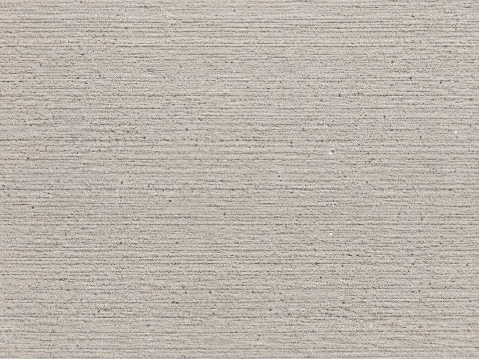 Broom-finished concrete with fine parallel grooves.