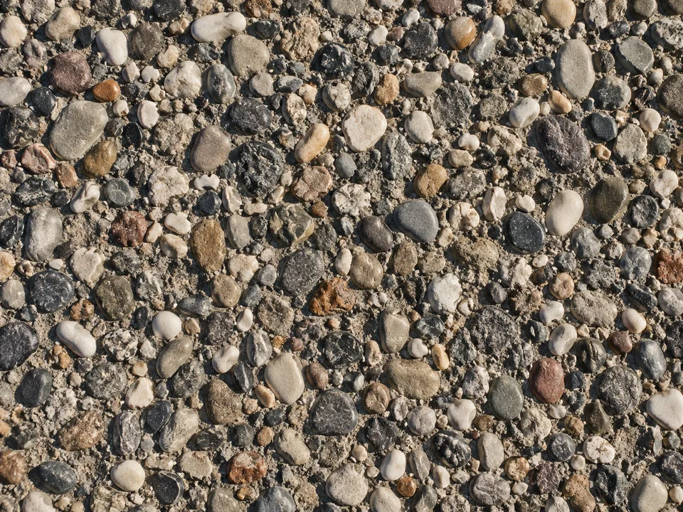 Exposed-aggregate concrete with visible mixed pebbles.